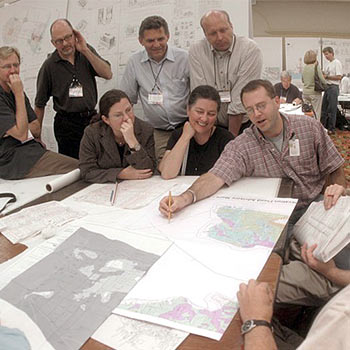 People discussing an urban plan on top of a table