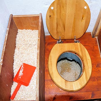 sawdust beside a wood toilet