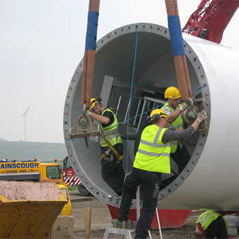Wind turbine being installed by workers